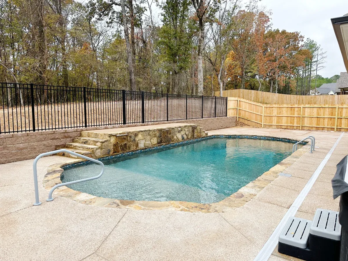 Rectangle pool construction with an iron rail feature.