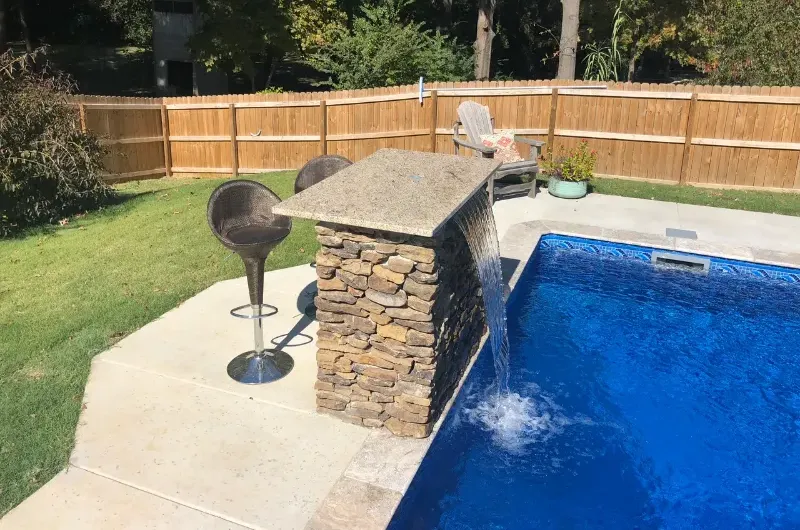 Pool side bar with a natural stone waterfall.