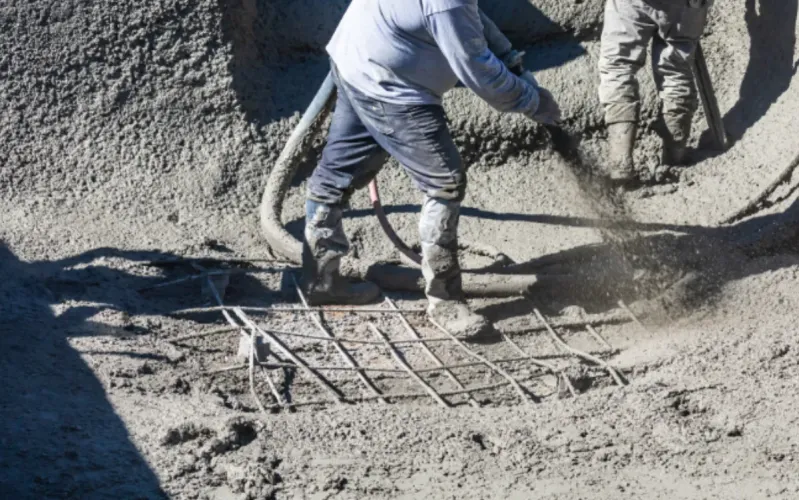 Gunite concrete installation during pool construction.