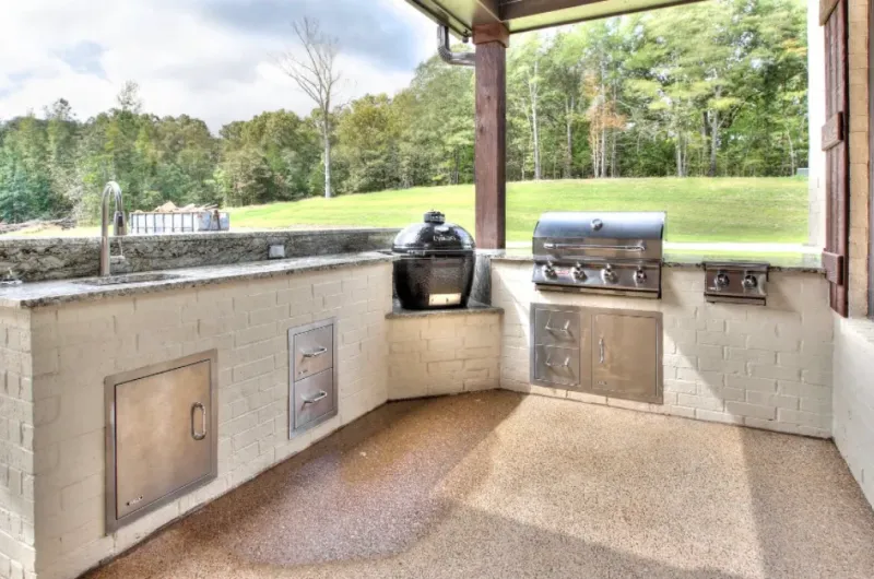 Outdoor grill and kitchen under custom patio.