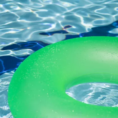 Green pool dloat on deep blue water.