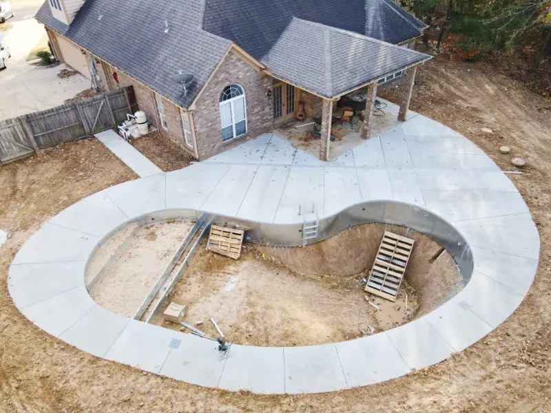 A custom pool and deck shape during concrete pour.