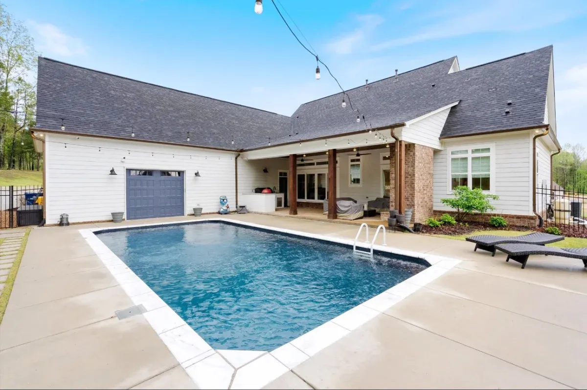 Rectangle pool with an angkled corner and tile for easy access or sitting.